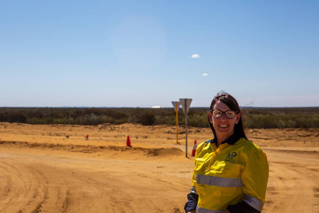 Lady minder smiling at mining site